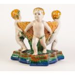 MINTON STYLE MAJOLICA POTTERY TABLE CENTREPIECE BOWL, modelled as three cherubs supporting an