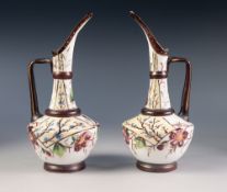 PAIR OF NINETEENTH CENTURY ENAMELLED WHITE GLASS EWERS, floral painted in colours, 9 ¾" (24.8cm)
