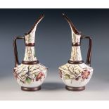 PAIR OF NINETEENTH CENTURY ENAMELLED WHITE GLASS EWERS, floral painted in colours, 9 ¾" (24.8cm)