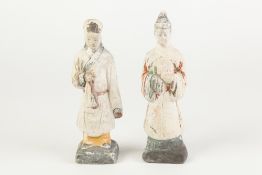 A PAIR OF AGED CHINESE WHITE CHALK SURFACED TERRACOTTA BISCUIT ATTENDANT FIGURES with remnants of