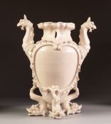 A LATE NINETEENTH CENTURY CONTINENTAL CREAM GLAZED PORCELAIN TWO HANDLED VASE, the body with
