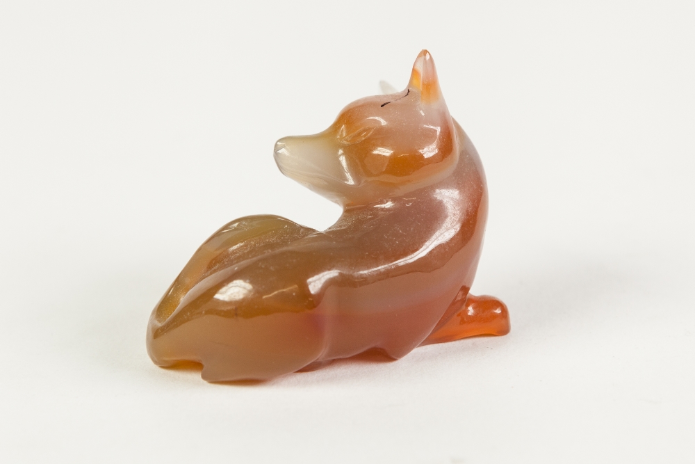 A CHINESE SMALL GREY AND RUSSET COLOURED JADE MODEL OF A RECUMBENT FOX, 2" (5cm) long - Image 2 of 2