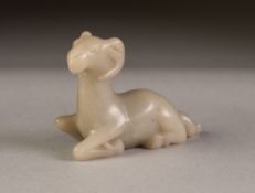 CHINESE CARVED MUTTON FAT JADE COLOURED HARDSTONE MODEL OF A RAM, modelled kneeling, 2 ½" (6.3cm)