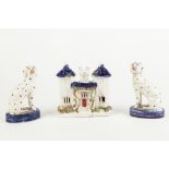 PAIR OF VICTORIAN STAFFORDSHIRE POTTERY SEATED DALMATIANS on blue glazed oval bases, 5 1/4" (13.5cm)