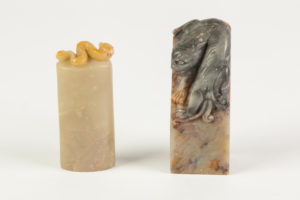 A CHINESE LIGHT BROWN SOAPSTONE SEAL of oval section carved with a surmounting mythical beast, 2 1/