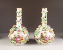 A PAIR OF LATE NINETEENTH CENTURY DRESDEN PORCELAIN BOTTLE SHAPED VASES, each encrusted with