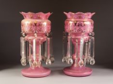 PAIR OF LATE NINETEENTH CENTURY PINK CASED GLASS TABLE LUSTRES, of typical form with wavy rim and