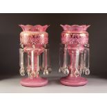 PAIR OF LATE NINETEENTH CENTURY PINK CASED GLASS TABLE LUSTRES, of typical form with wavy rim and