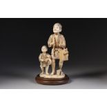 A GOOD JAPANESE MEIJI PERIOD SECTIONAL CARVED IVORY OKIMONO OF A FATHER AND SON AS ITINERANT