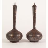 PAIR OF MIDDLE EASTERN GOLD INLAID WHITE METAL VASES AND COVERS, each of globe and shaft form with