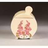 A 1930's CLARICE CLIFF (Wilkinson Ltd) DRUM SHAPED PRESERVES JAR with cover, painted with Hollyhocks