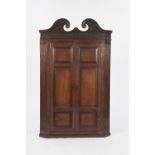 NINETEENTH CENTURY OAK CORNER CUPBOARD, the swan neck pediment above a blind fret carved frieze