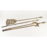 SET OF THREE AGED BRASS FIRE TOOLS, each with ring suspension to the tapering handle, 32" (81.3cm)