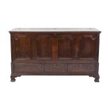 EIGHTEENTH CENTURY OAK DOWER CHEST, the part hinged oblong top above a four panelled front and three