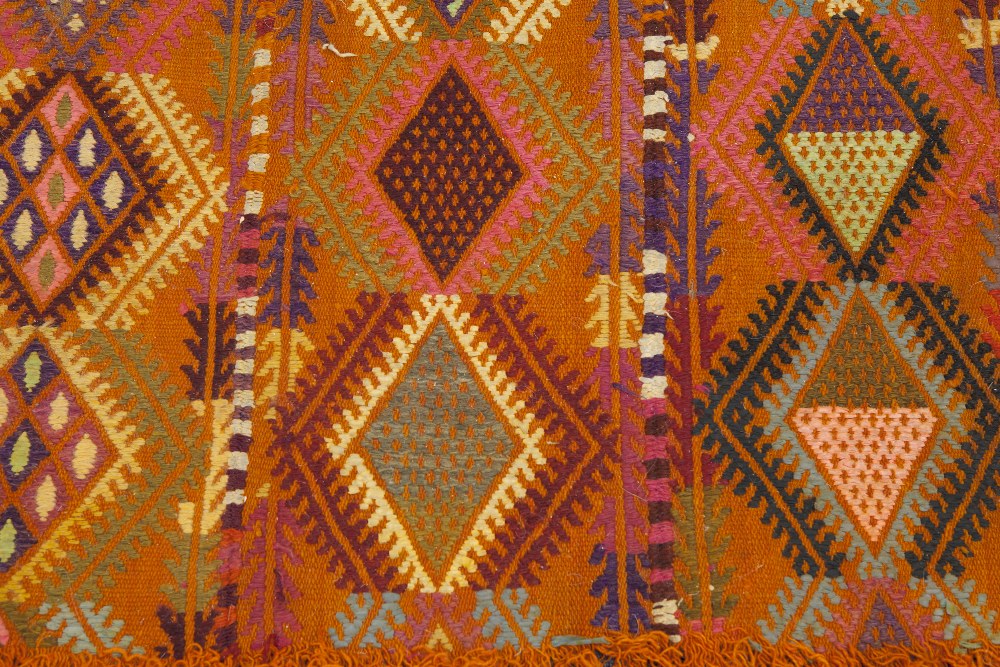 HAND WOVEN KELIM RUG, with four rows of diamond shaped pole medallions on an orange field, 5' 4" x - Image 2 of 4