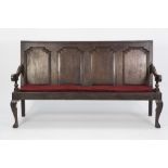 GEORGE III OAK SETTLE, of typical form with four panel back, downswept arms with turned terminals,