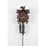 MODERN BLACK FOREST CARVED SOFTWOOD SMALL CUCKOO CLOCK, with pine cone pattern weights, together