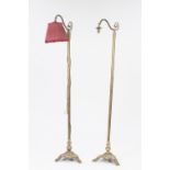 PAIR OF EDWARDIAN BRASS STANDARD LAMPS, each with plain column, scroll arm and tri form base with