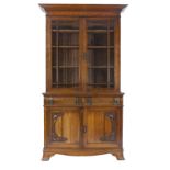 EARLY TWENTIETH CENTURY ARTS AND CRAFTS CARVED OAK LIBRARY BOOKCASE, the dentil moulded cornice