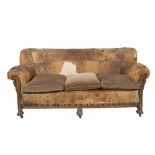 EARLY TWENTIETH CENTURY CARVED OAK FRAMED HIDE THREE PIECE SUITE, comprising: three seater settee