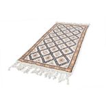 EASTERN RUG, decorated with rectangular guls within a trellis pattern on an off white field, the