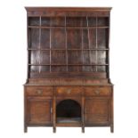 LATE EIGHTEENTH/ EARLY NINETEENTH CENTURY OAK SMALL DRESSER WITH PLATE RACK, the moulded cornice