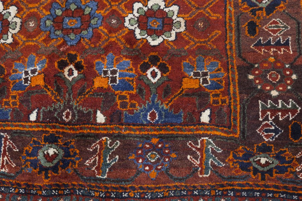 SHIRAZ TRIBAL RUG, with an all-over design of large flowers on a crimson field, broad border with - Image 2 of 2