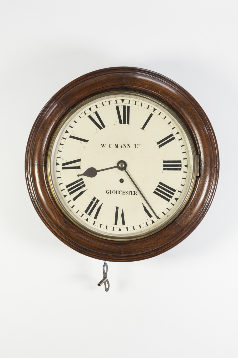 W.C. MANN Ltd, GLOUCESTER, EARLY TWENTIETH CENTURY WALL CLOCK, the 11 ½" painted Roman dial