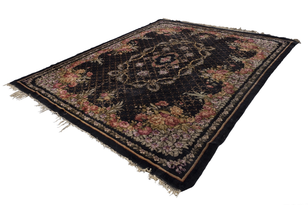 PROBABLY FRENCH SEMI ANTIQUE HAND WOVEN ALL-WOOL CARPET, with large oval floral wreath and ribbon on