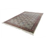 LARGE EASTERN WOOL CARPET, with an all over multi coloured repeat pattern of stylized flowers with