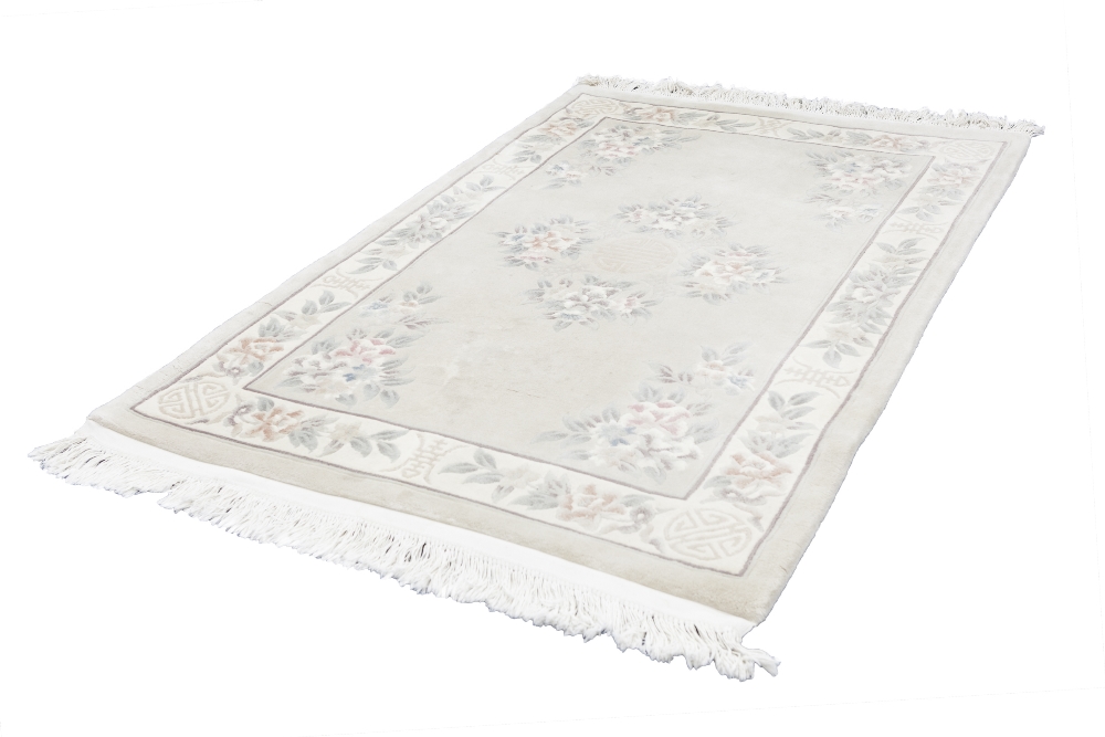 LARGE WASHED CHINESE EMBOSSED RUG, with floral centre medallion with mon and floral spandrels, on