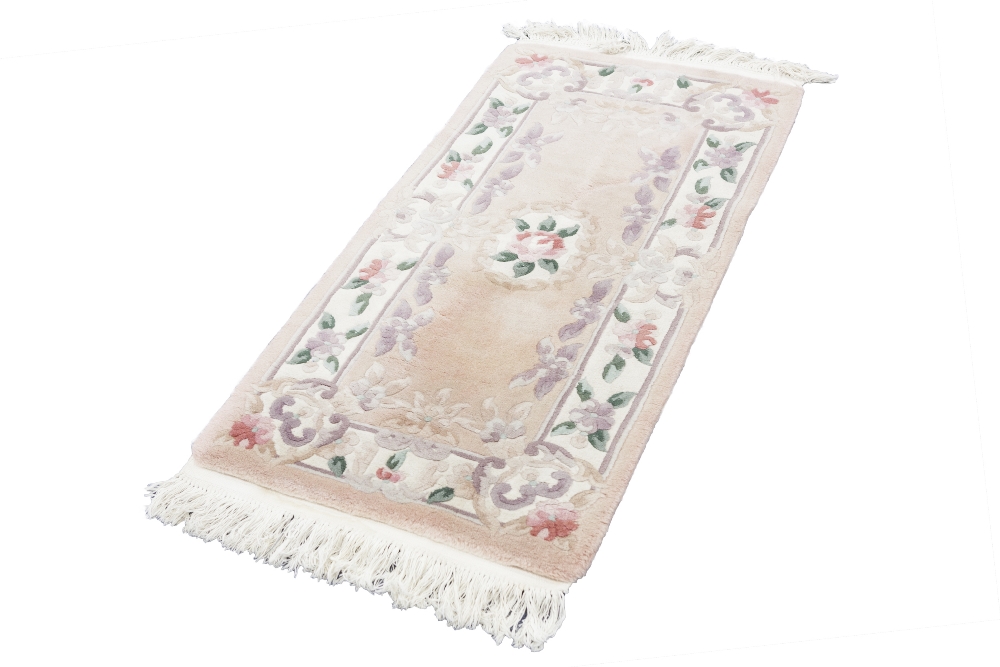 WASHED CHINESE 'KAYARN' SUPER QUALITY, ALL WOOL, EMBOSSED RUG, with three floral motifs on a pink