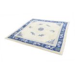 CHINESE CARPET, off white field with blue small circular centre medallion, scattered utensils and