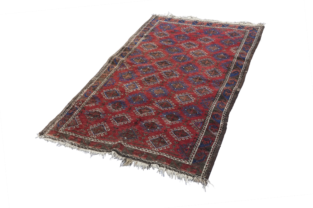 TURKOMAN TRIBAL RUG, with an all-over pattern of diamond shaped guls on a crimson field, crimson