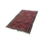TURKOMAN TRIBAL RUG, with an all-over pattern of diamond shaped guls on a crimson field, crimson