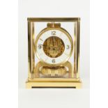 JAEGAR-LE-COULTRE GILT BRASS CASED ATMOS MANTLE CLOCK, the white chapter ring with raised Arabic and