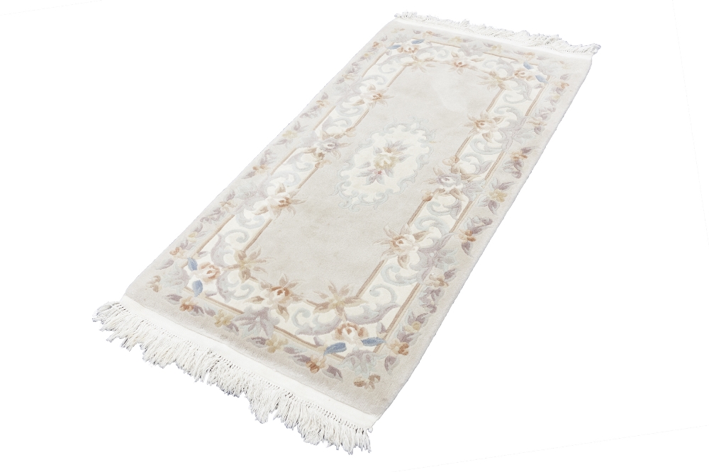 WASHED CHINESE EMBOSSED RUG, with Aubusson design on mushroom field with off white border, 5' x 2'6"