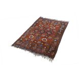 SHIRAZ TRIBAL RUG, with an all-over design of large flowers on a crimson field, broad border with