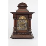 EARLY TWENTIETH CENTURY WALNUT CASED MANTLE CLOCK BY JUNGHANS, the 6 ½" brass dial with silvered