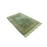 HEAVY QUALITY WASHED CHINESE RUG the pale grey/green ground plain with three large naturalistic rose