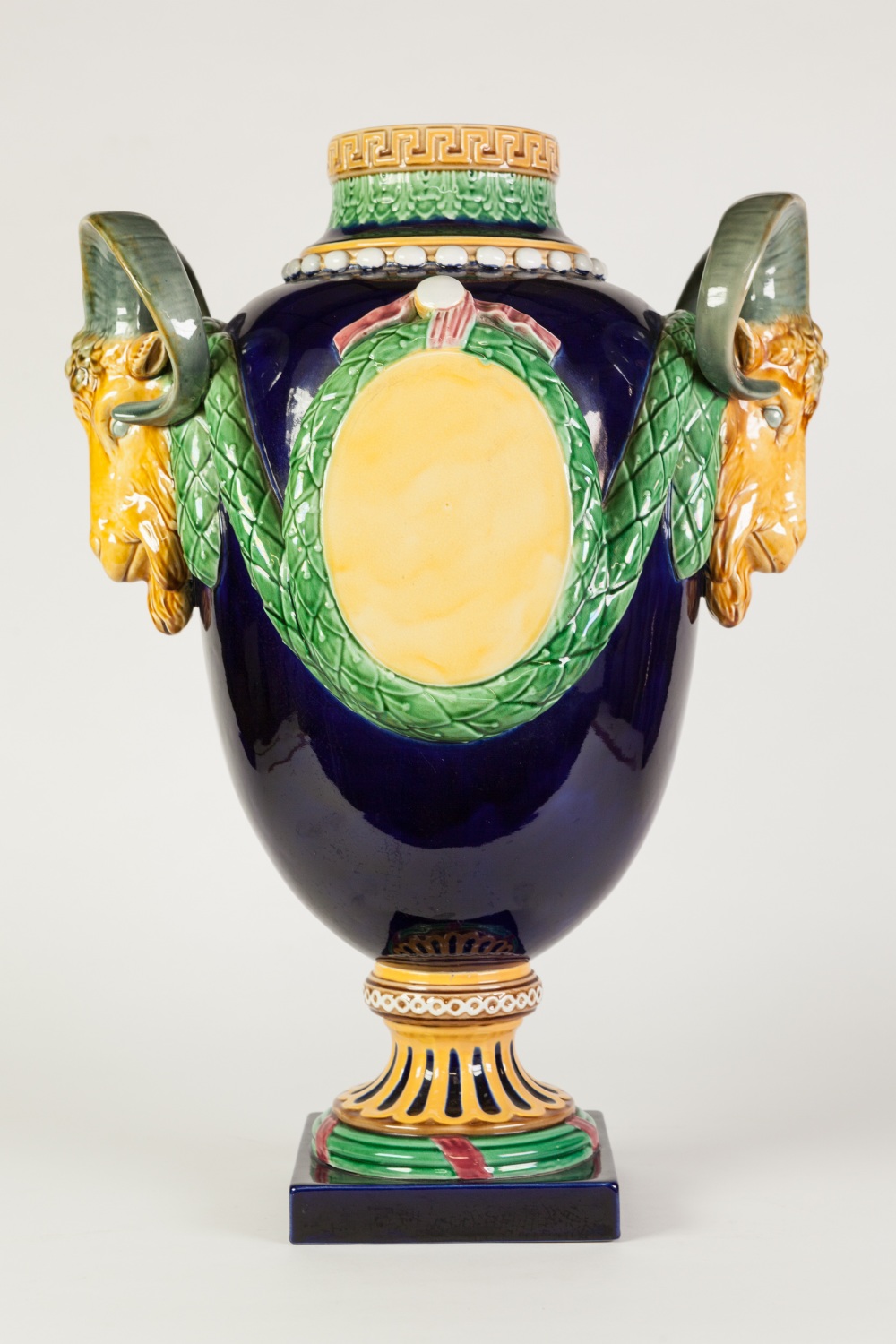 IMPRESSIVE MINTON STYLE MOULDED POTTERY LARGE TWO HANDLED PEDESTAL VASE, of ovoid form with rams