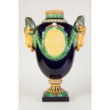 IMPRESSIVE MINTON STYLE MOULDED POTTERY LARGE TWO HANDLED PEDESTAL VASE, of ovoid form with rams