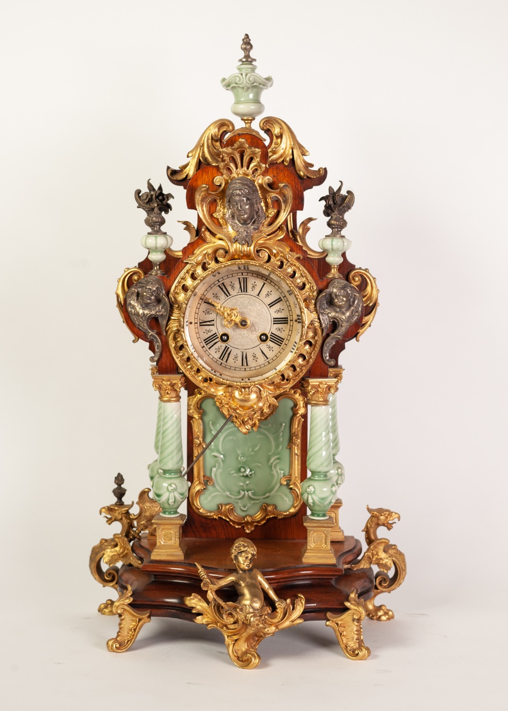 REPRODUCTION GILT METAL AND CELADON GLAZED PORCELAIN MOUNTED MAHOGANY MANTLE CLOCK IN THE ROCOCO