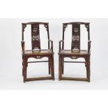 PAIR OF CHINESE CARVED AND RED STAINED ELM OPEN ARMCHAIRS, each with a shaped top rail above a
