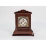 EARLY TWENTIETH CENTURY WALNUT AND STAINED FRUITWOOD MANTLE CLOCK, the 6" silvered Roman dial with