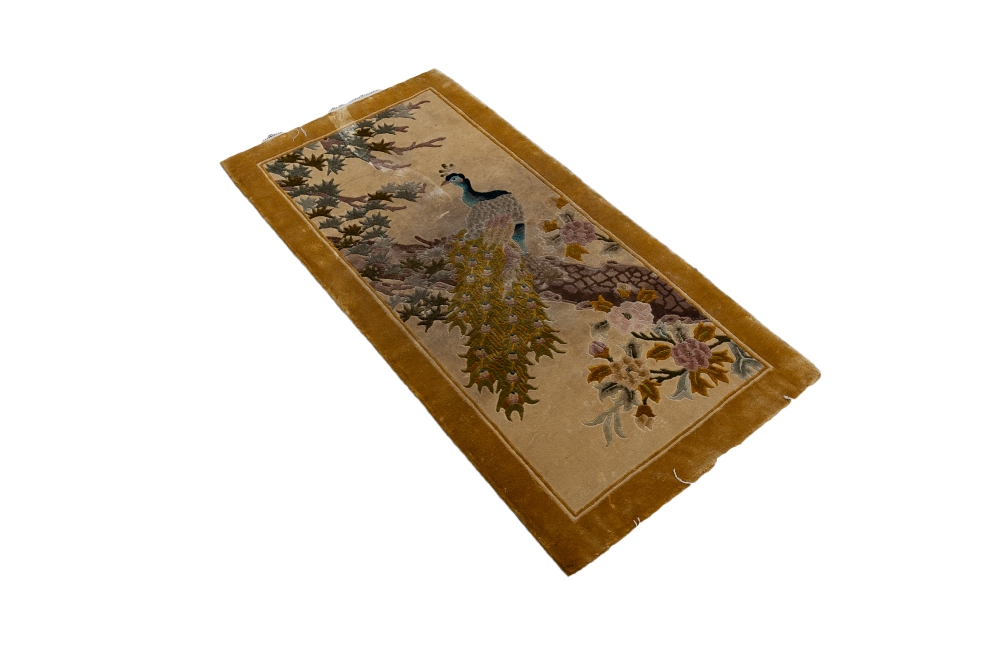 WASHED CHINESE SILKY PILE EMBOSSED PICTORIAL RUG depicting a peacock in a tree, fawn background,