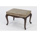 LATE NINETEENTH CENTURY CARVED WALNUT STAINED BEECH DRESSING TABLE STOOL, the oblong padded seat