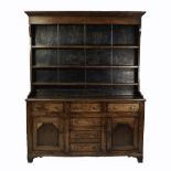 NINETEENTH CENTURY OAK DRESSER, the boarded plate rack with moulded cornice and three shelves, the