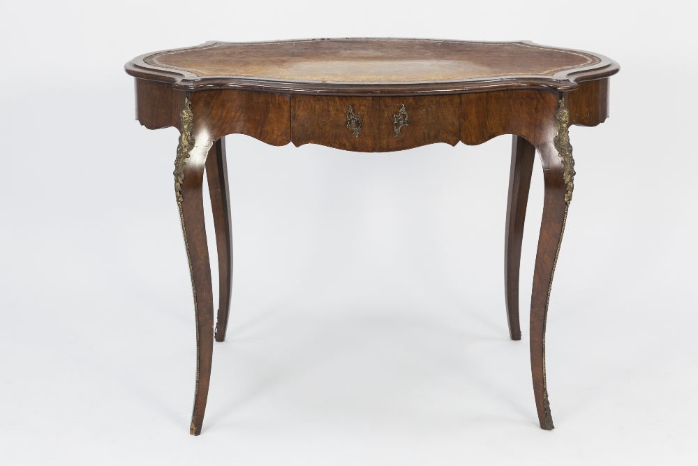 MID TWENTIETH CENTURY FRENCH WALNUT AND GILT METAL MOUNTED BUREAU PLAT, the oval, crossbanded top