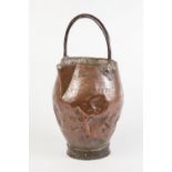 AN ANTIQUE COPPER JUG, bellied form with pinched spout, hammered band marking, riveted overhead